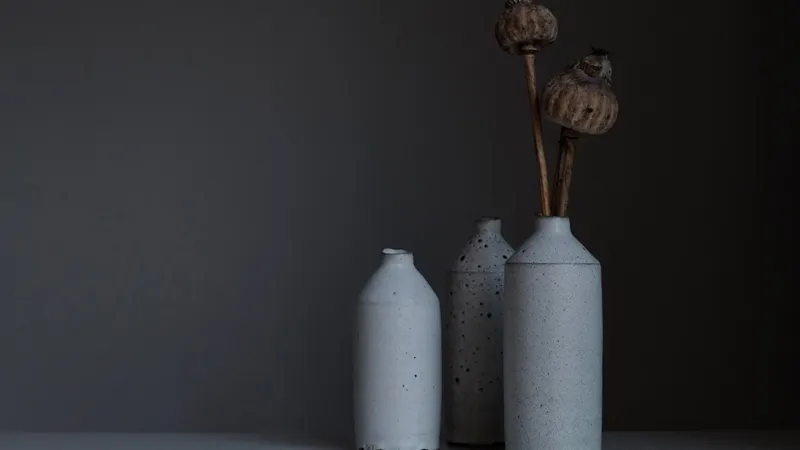 Ceramic artist working at pottery wheel in bright studio